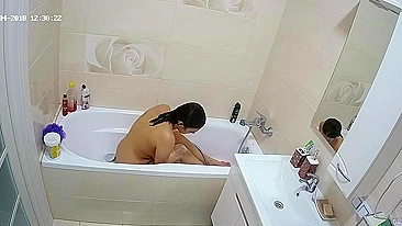 Curvy caught sister is getting wet in the bathtub while being caught on camera