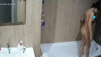 A tall woman talks on the phone before hopping in the tub in this caught sister