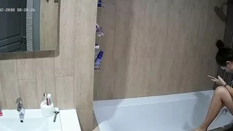 A tall woman talks on the phone before hopping in the tub in this caught sister A tall woman talks on the phone before hopping in the tub in this caught sister