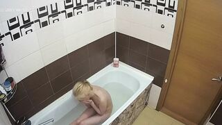 A hidden cam caught sister with natural tits naked while enjoying her bath