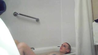 A blonde woman with a shaved pussy and a fit body is caught sister in the shower