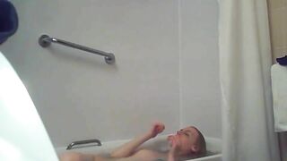 A blonde woman with a shaved pussy and a fit body is caught sister in the shower