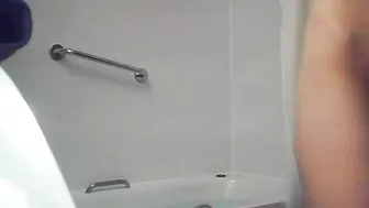 A blonde woman with a shaved pussy and a fit body is caught sister in the shower