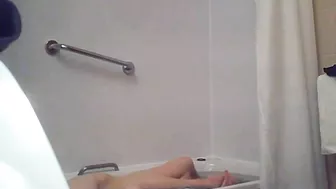A blonde woman with a shaved pussy and a fit body is caught sister in the shower