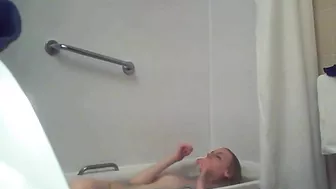 A blonde woman with a shaved pussy and a fit body is caught sister in the shower