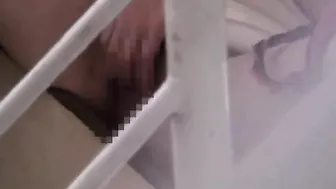 Hot Japanese babe pleasures herself while being watched by a voyeur.