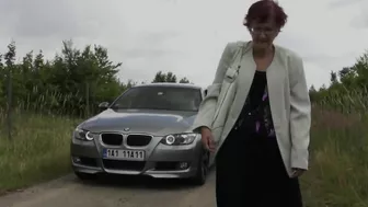 Rich dude stops his expensive car to pick up old red-haired granny with glasses for outdoor blowjob
