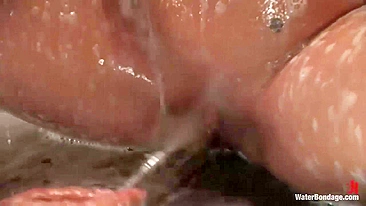 Handcuffed girl spanked with flogger under streams of water