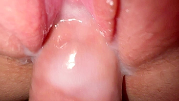 Sexy young girl with incredibly tight and creamy pussy in close-up shot.