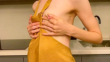 A young mother displays her petite, unaugmented breasts in a natural state, suitable for viewing by mature audiences on an adult website.