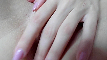 Sexy teen masturbates with spread pussy in close-up shot.