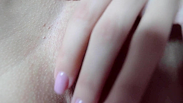 Sexy teen masturbates with spread pussy in close-up shot.