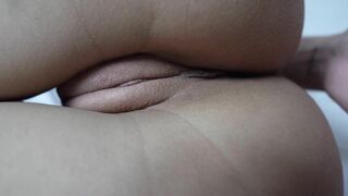 A close-up shot of a shaved pussy being masturbated.