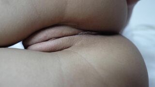 A close-up shot of a shaved pussy being masturbated.