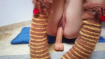 Teen girl pleasures herself with massive sex toy while wearing socks.