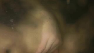 Fingering red hair pussy while teasing big natural breasts underwater in a bath.