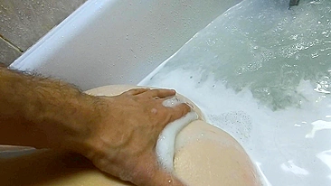 Rub your back while enjoying wet ginger teen pussy in a foamy bath at home.