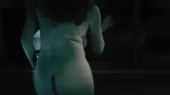 Redheaded girl dancing nude in rain with big natural breasts.