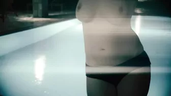 Redheaded girl dancing nude in rain with big natural breasts.