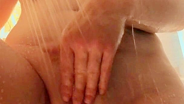 Gorgeous busty woman showers with round ass and cum shot.