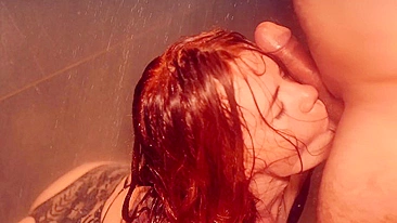 Red-haired beauty gives long, sensuous blowjob and worships cock in hot shower.