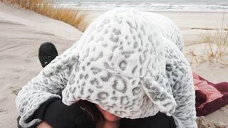 Red-haired amateur enjoys cold winter beach blowjob and swallows cum in a public setting.