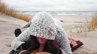 Red-haired amateur enjoys cold winter beach blowjob and swallows cum in a public setting.