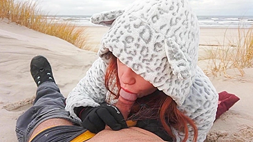 Red-haired amateur enjoys cold winter beach blowjob and swallows cum in a public setting.