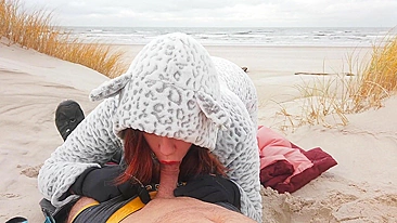 Red-haired amateur enjoys cold winter beach blowjob and swallows cum in a public setting.