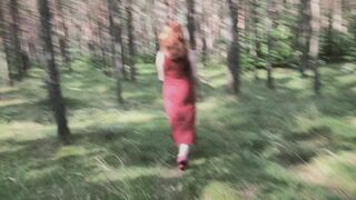 Redhead teases by flashing big boobs while peeing in forest.