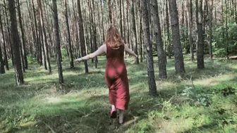 Redhead teases by flashing big boobs while peeing in forest.