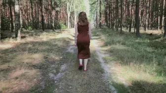 Redhead teases by flashing big boobs while peeing in forest.