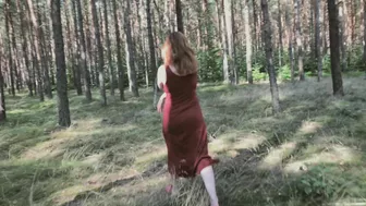 Redhead teases by flashing big boobs while peeing in forest.