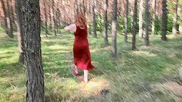 Redhead teases by flashing big boobs while peeing in forest.