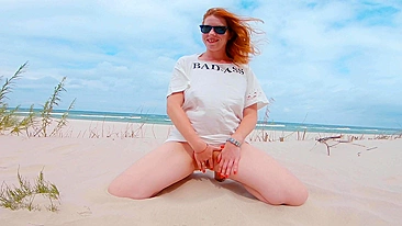 Red-haired woman flashes and performs oral sex on beach before receiving a large cum shot in public.