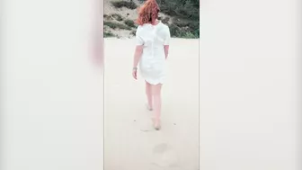 Redhead in white dress flashes and blows at risky public beach; cumshot ensues.