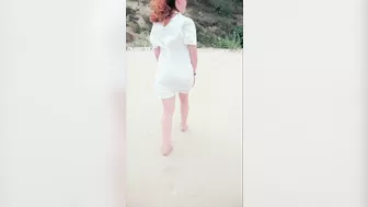 Redhead in white dress flashes and blows at risky public beach; cumshot ensues.