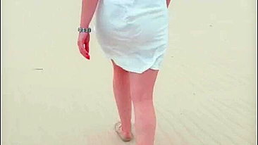 Redhead in white dress flashes and blows at risky public beach; cumshot ensues.