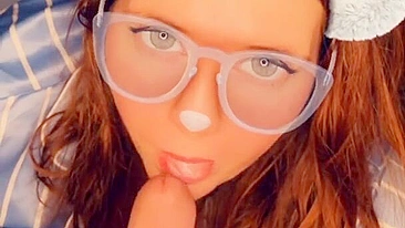 A redhead in glasses sucks cock until she orgasms on camera.