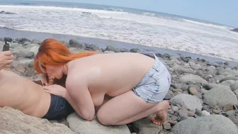 Red-haired babe gives blowjob and handjob on public beach.