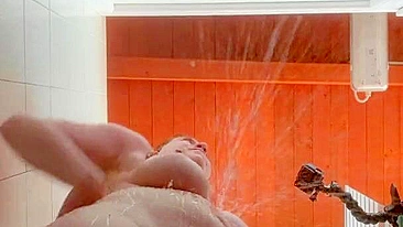 A curvy ginger with big tits bounces while showering in a wet and sloppy public camping area.