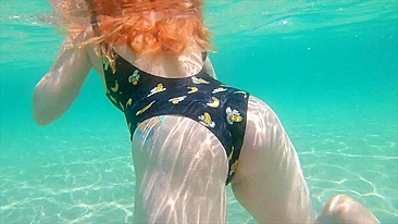 Risky beach handjob underwater cumshot with curvy redhead.