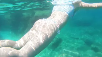 Curvy redhead gets risky handjob on public beach with big tits and cumshot.