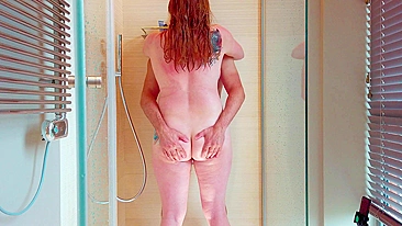 Redhead with big tits and thick thighs masturbates in the shower until she cums between her legs.