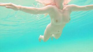 Curvy ginger teen swims nude and pees in sea.