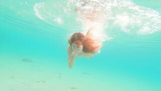 Curvy ginger teen swims nude and pees in sea.