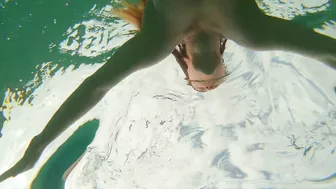 Curvy ginger teen swims nude and pees in sea.