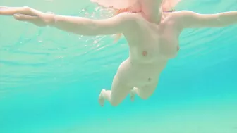 Curvy ginger teen swims nude and pees in sea.