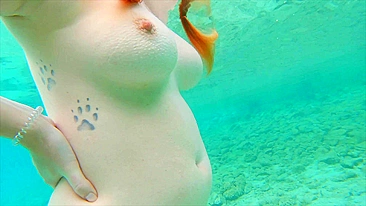 Curvy ginger teen swims nude and pees in sea.