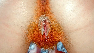 Redhead pussy slides in close-up during ginger bush creampie fuck.